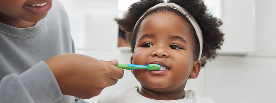 parents brushing child's teeth