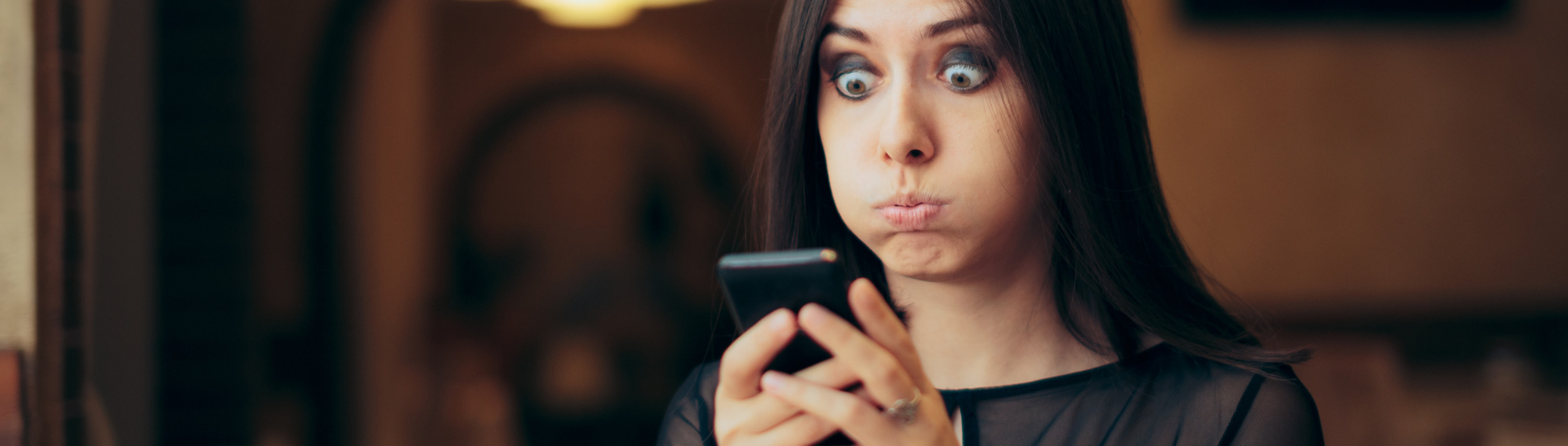 woman looking at text suprised