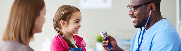 Doctor with young child smiling