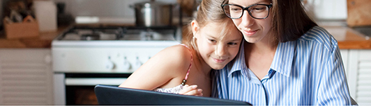 Mother using laptop to report immunization